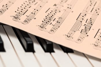 music notes on top of piano keys