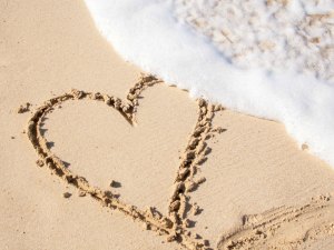 un corazón dibujado en la arena de la playa