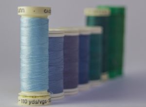 different color sewing threads next to each other