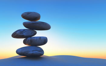 a pile of stones balancing on one another in the desert