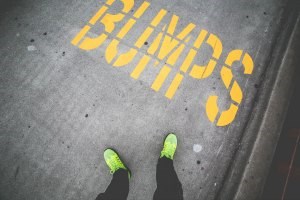 the word bumps painted in yellow onto a road