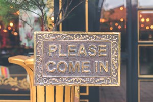 sign inviting people to come into a store