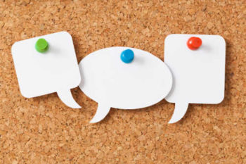 three speech bubbles pinned to a cork board