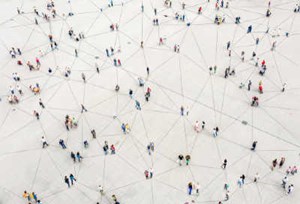 group of people standing apart from one another connected by lines on the ground